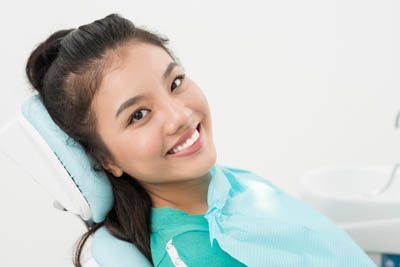 patient smiling after her dental procedure at Passes Dental Care