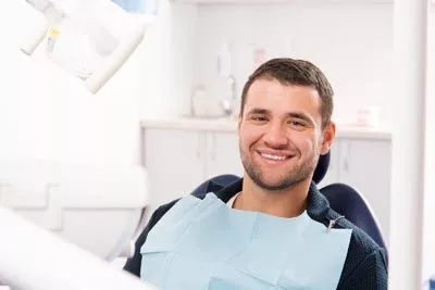 patient smiling before a dental procedure at Passes Dental Care