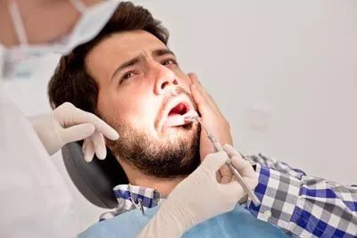patient visiting the dentist after hurting his mouth