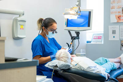 dental assistant assisting with an emergency dentistry procedure